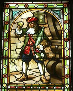 Glass painting of Perkeo shown with his three symbols wine goblet, key and clock. Photo Credit