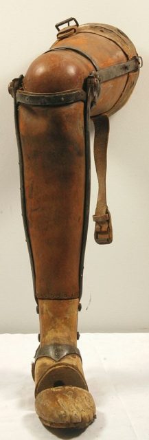 An articulated wood and leather prosthetic leg