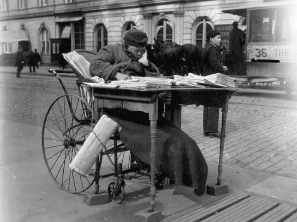 Newspaper vendor. Photo Credit