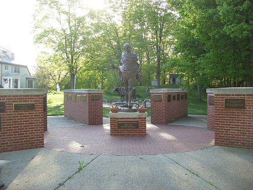 Statue of Mahatma Gandhi at “Peace Abbey” in Sherborn; A life-sized bronze statue of Emily is behind. Photo Credit