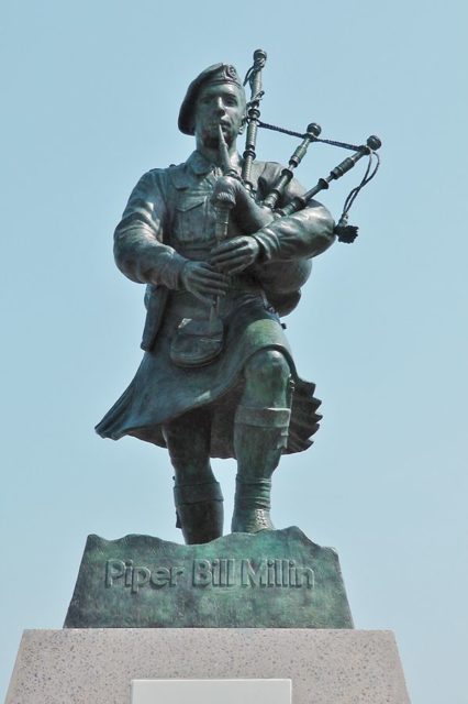 The life-size bronze statue of Piper Bill Millin at Sword Beach, Colleville-Montgomery in Normandy, France. Photo Credit