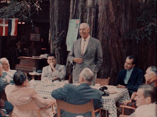 Harvey Hancock standing and speaking to a group of Bohemian Club members at the Owl’s Nest camp of the Bohemian Grove over breakfast on July 23, 1967. In attendance: Preston Hotchkis, California Governor Ronald W. Reagan, Former US Vice President Richard M. Nixon, Glenn Seaborg, Jack Sparks, (unidentified individual), (unidentified individual), and Edwin Pauley.