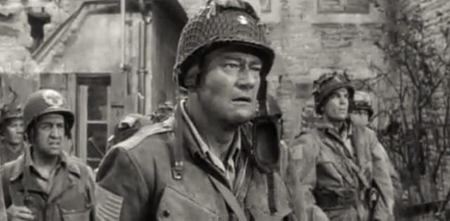 Screenshot from the epic war film about the D-Day landings, The Longest Day, in which Bill Millin is portrayed by Leslie de Laspee, the official piper to the Queen Mother. The cast includes John Wayne, Kenneth More, Sean Connery, and Henry Fonda.