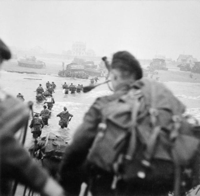 Landing on Sword Beach. Millin is in the foreground at the right, while Lovat is wading through the water to the right of the column.