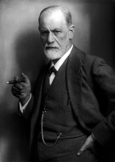 Sigmund Freud, founder of psychoanalysis, holding a cigar.