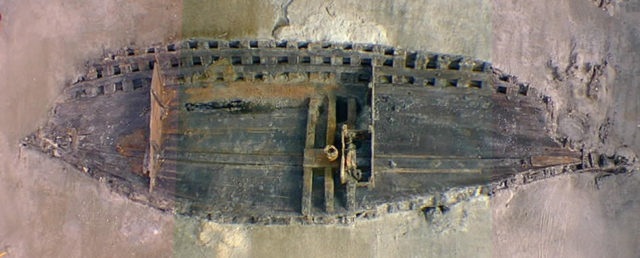 Composite image from three photographs looking down at the excavated wooden hull remains of the Belle shipwreck, excavated by the Texas Historical Commission in 1995. Photo Credit