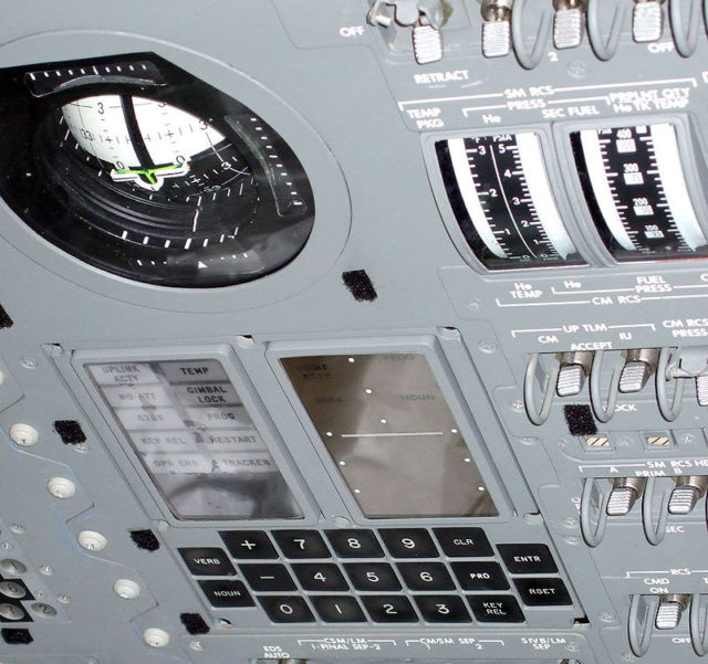 The display and keyboard (DSKY) interface of the Apollo Guidance Computer mounted on the control panel of the Command Module, with the Flight Director Attitude Indicator (FDAI) above