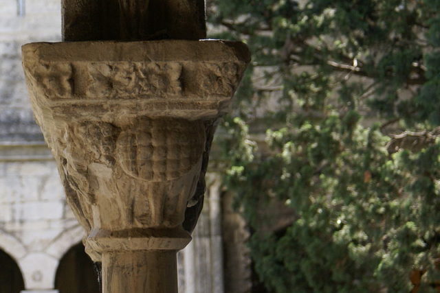A carved early Gothic column capital in the cloister of the Church of St. Trophime in Arles, 14th century, depicting the Tarasque  Photo Credit