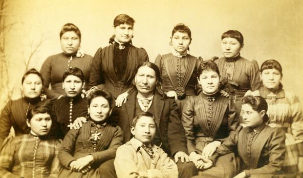 American Horse at Carlisle, 1882, with his daughter Maggie Stands Looking with other Indian students and teachers. Maggie Stands Looking was one of Captain Pratt’s model students