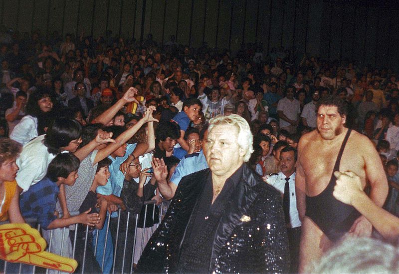 André was managed by Bobby Heenan (seen in front of him) during parts of his feud with Hulk Hogan. Photo Credit