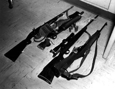 Whitman’s rifles and a sawed-off shotgun. Photo Credit