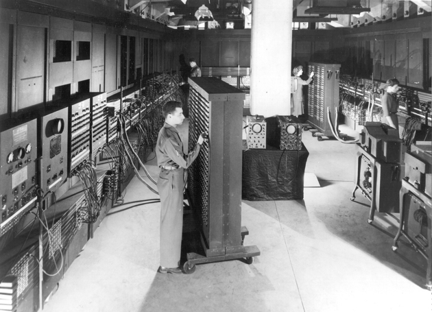 Cpl. Irwin Goldstein (foreground) sets the switches on one of ENIAC’s function tables at the Moore School of Electrical Engineering. (U.S. Army photo)
