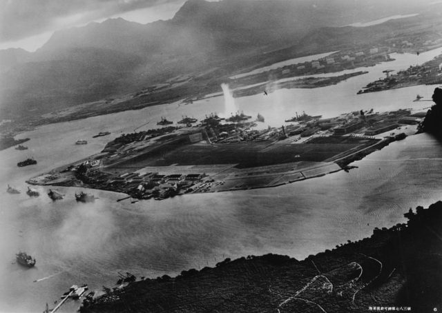Photograph from a Japanese plane of Battleship Row prior to the attack. The explosion in the center is a torpedo strike on USS West Virginia.