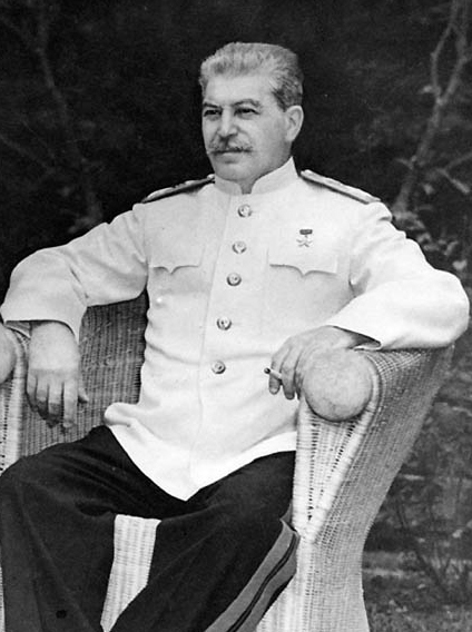 Joseph Stalin, seated outdoors at Berlin conference