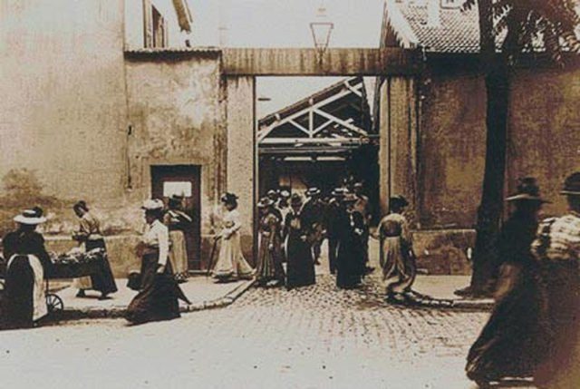 The entrance to the Institut Lumière in 2014, with a glass projection displaying a frame from the film where factory workers were captured on film leaving the factory