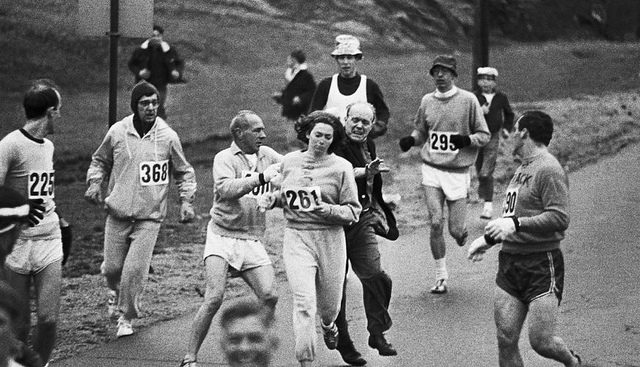 A Boston Marathon official tried to hustle Kathrine Switzer, No. 261, off the course during the race in 1967. Photo Credit