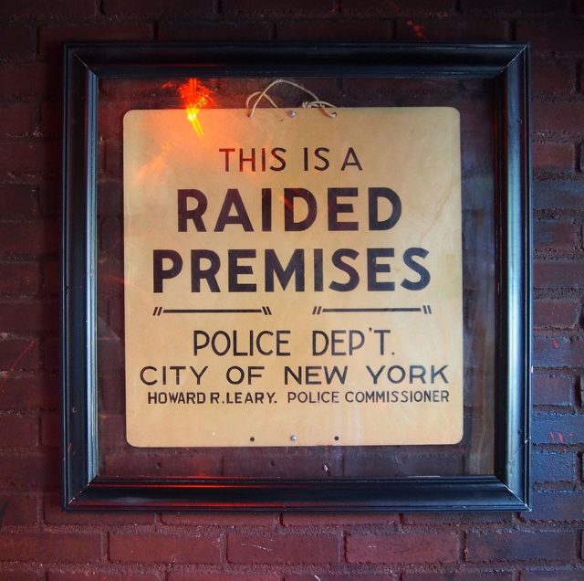 The sign left by police following the raid is now hanging just inside the entrance. photo credit