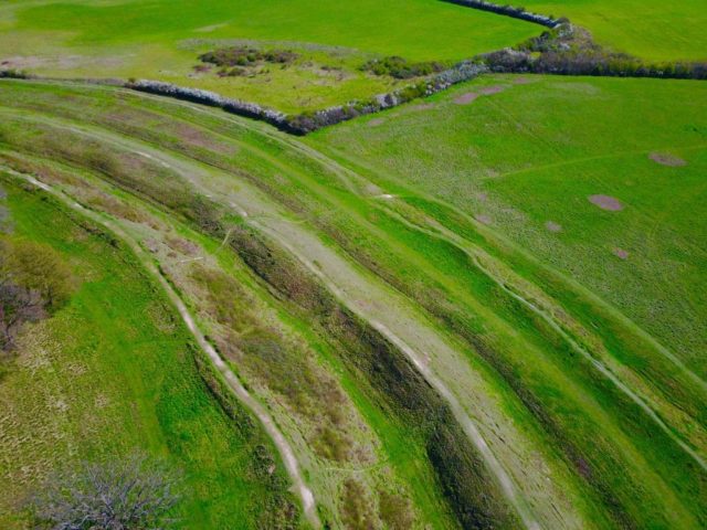 It has three concentric ditches and ramparts and is nearly a mile in circumference.