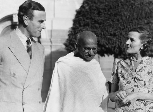 Mahatma Gandhi, preeminent leader of Indian nationalism in British-ruled India with Lord and Lady Mountbatten, outside Government House, New Delhi, 1947.