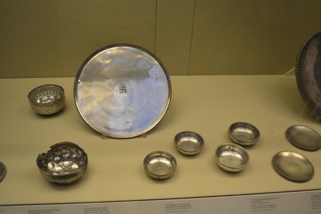 The silver plate with the swastika at the center