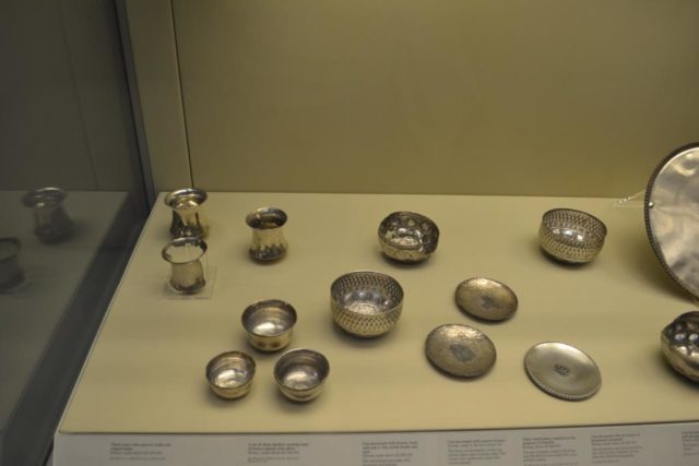 Various bowls and small plates including the Genialis plate with a rosette at the center on the right