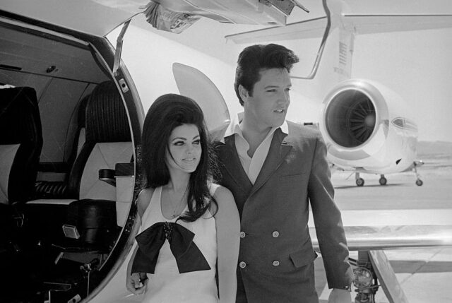 Priscilla and Elvis Presley standing outside of a private jet