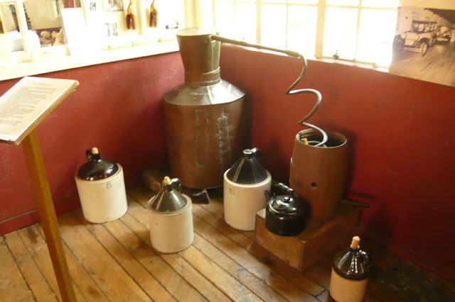 A historical moonshine distilling-apparatus in a museum. Photo Credit
