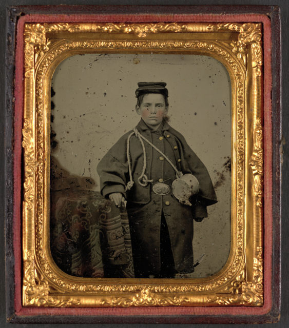 Drummer boy Johnny Jacobs in Union uniform with cup. Photo Credit