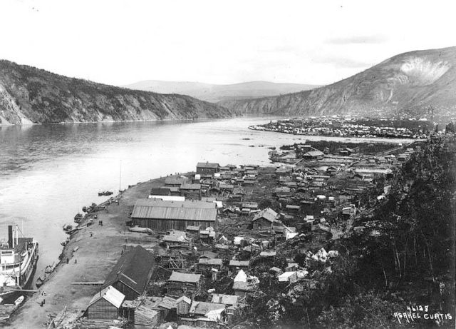 View of Yukon River with Klondike City (foreground) and Dawson City (upper right at the mouth of Klondike River), 1899