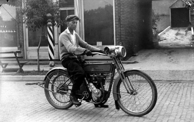 Don Whitlock’s Harley Davidson. On Vine street in front of Davis Brothers elevator driveway, December 1915