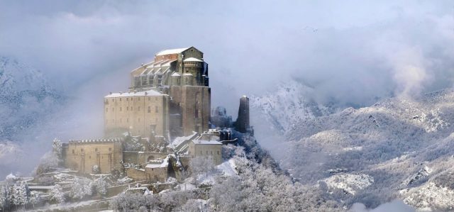 Saint Michael’s Abbey, in the Susa Valley, Piedmont, which inspired the fictional monastery in Eco’s “The Name of the Rose”  Photo Credit: Elio Pallard CC BY-SA 4.0