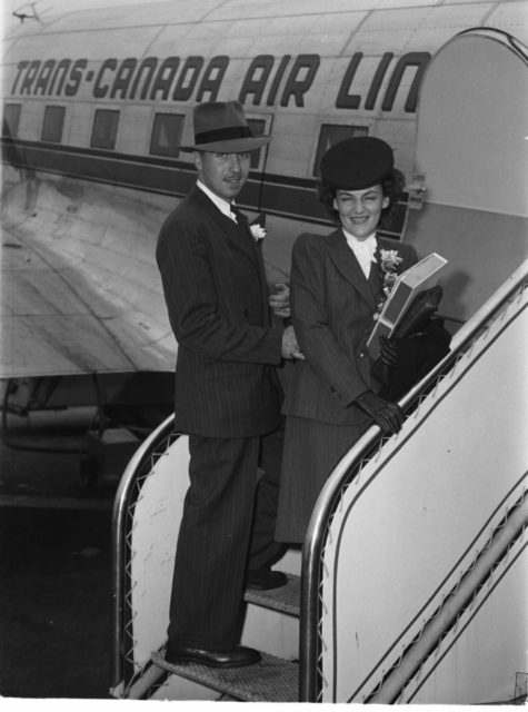 The newlyweds, Ms. Yvette Villebon, and her husband, are on the steps of the staircase of a plane leaving on their honeymoon
