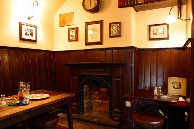 A corner of the Eagle and Child pub, formerly the landlord’s sitting-room where the Inklings met. There is a small display of memorabilia. Photo Credit