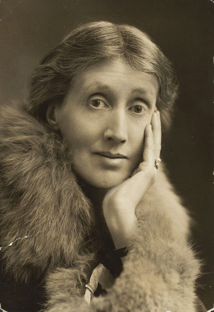 Photograph of Virginia Woolf with hand on face wearing a fur stole. This particular photograph is simply described as “Woolf Virginia [1927]”