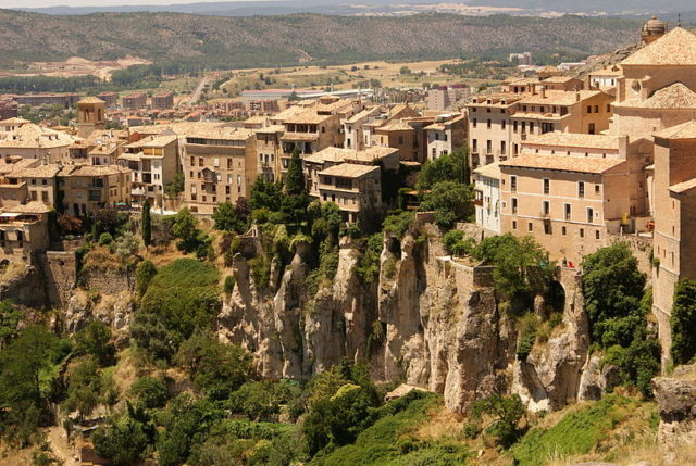 The old town of Cuenca sits on a hilltop, about 950 meters above sea level, surrounded by the ravines of the Jucar River and its tributary the Huecar. The Moorish layout of the town is still evident. Author – Jocelyn Kinghorn – CC BY-SA 2.0