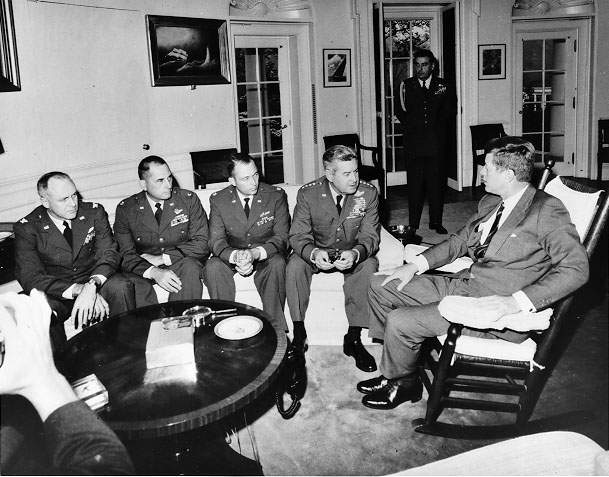 President Kennedy meets in the Oval Office with General Curtis LeMay and the reconnaissance pilots who found the missile sites in Cuba.