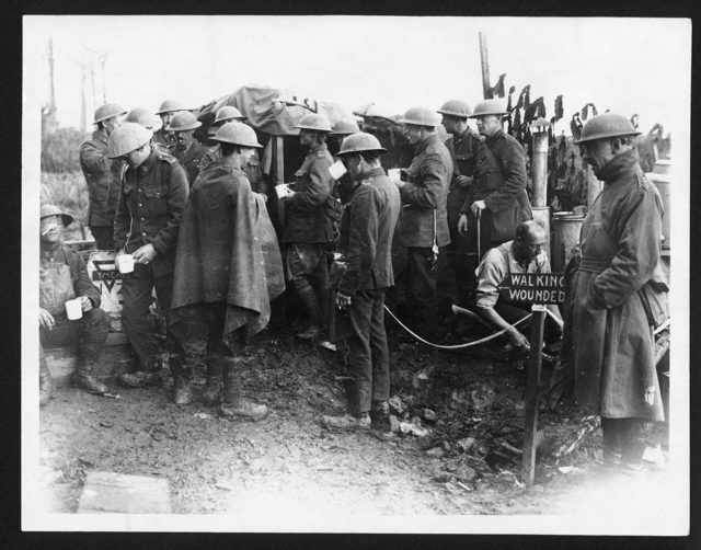 New Zealanders walking wounded at the Battle of Broodseinde ridge, the most successful Allied attack of Passchendaele. A YMCA NZ stall just behind the lines allowed the men to get something to drink.