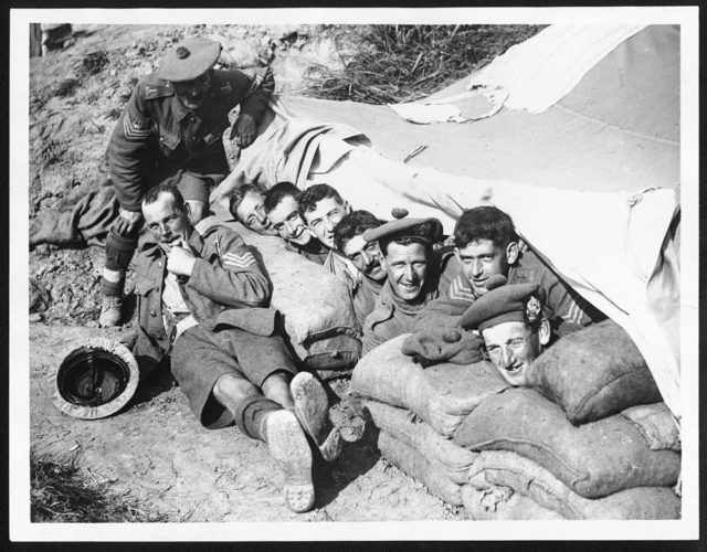 Men of the 6th Battalion, Argyll and Sutherland Highlanders, resting beneath a tarpaulin, Ypres-Comines Canal, October 1917