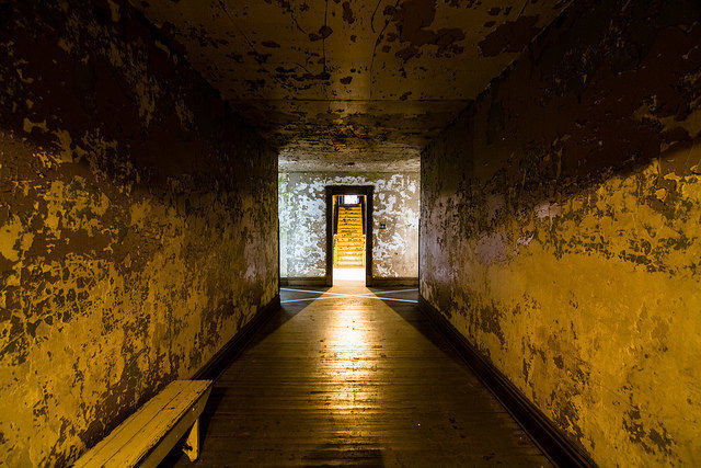 Looking at the X, a pattern of light formed by the architecture in this spot of the halls in the basement inside Ohio State Reformatory, Mansfield, Ohio. Author Rain0975, CC BY-ND 2.0