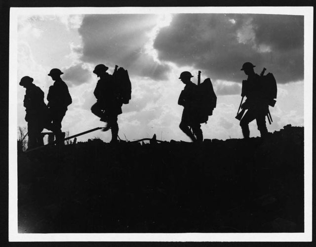 British soldiers moving forward during the Battle of Broodseinde. Photo by Ernest Brooks.