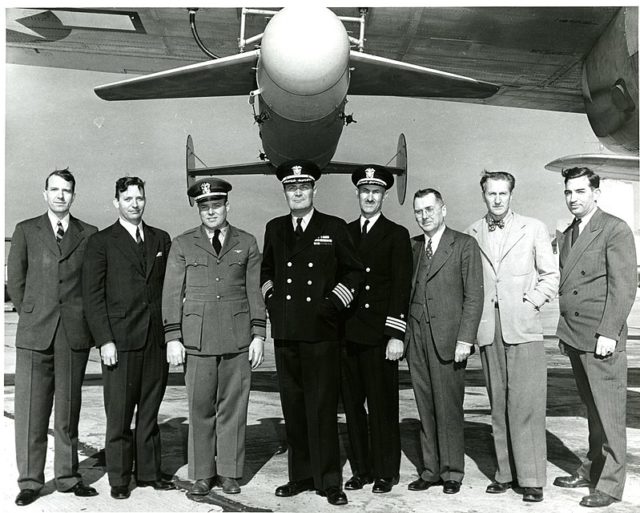 An American Bat anti-ship glide bomb, with its development team.