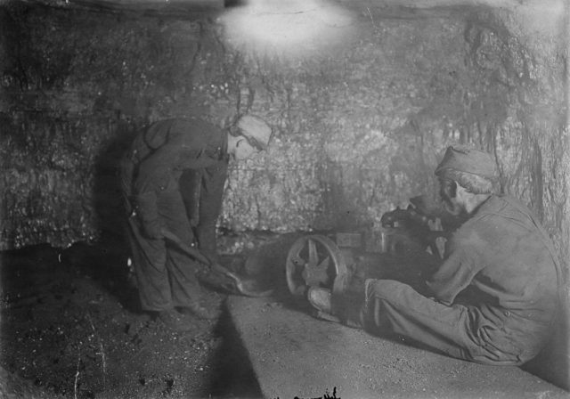 a-boy-shovels-loose-rock-in-a-mine-in-red-star-west-virginia West Virginia mine. Author:Lewis Hine/ Library of Congress