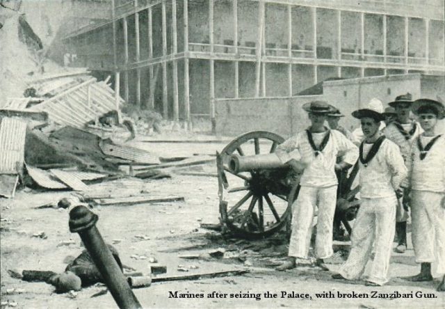 British sailors pose with a captured cannon outside the sultan’s palace.