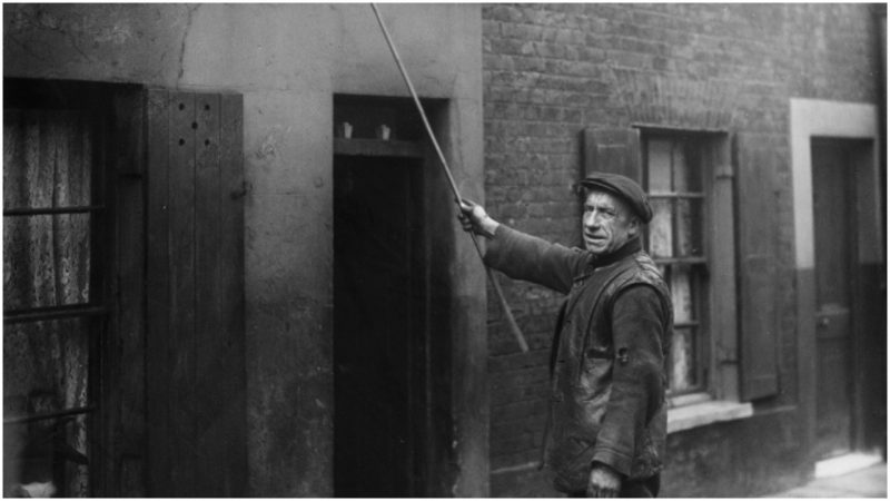 Early morning call January 24, 1929:  Charles Nelson of Hoxton in East London has been working as a "knocker-up" for 25 years. He wakes up early morning workers such as doctors, market traders and drivers.  (Photo by J. Gaiger/Topical Press Agency/Getty Images)