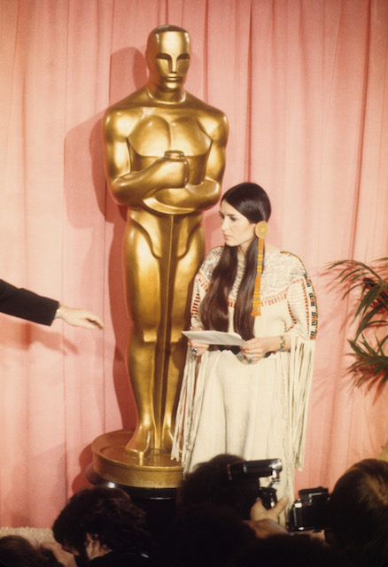 Sacheen Littlefeather (Native American actress Maria Cruz) holds a written statement from actor Marlon Brando refusing his Best Actor Oscar on stage at the Academy Awards on March 27, 1973 in Los Angeles, California. Photo by Michael Ochs Archvies/Getty Images