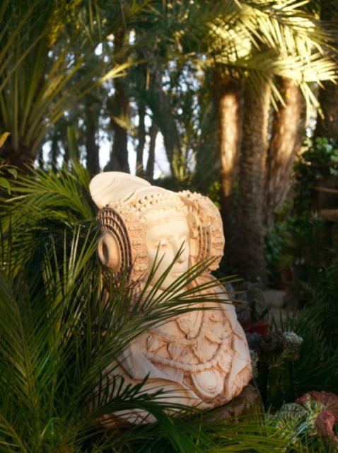 Dama de Elche figure in palm tree garden. Alicante. Spain. Vertical