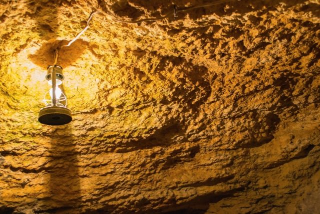 Old vintage light bulb next to Circle yellow cave ceiling