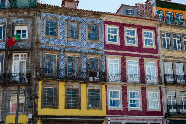 Typical Colorful Portuguese Architecture: Tile Azulejos Facade with Antique Windows And Balcony