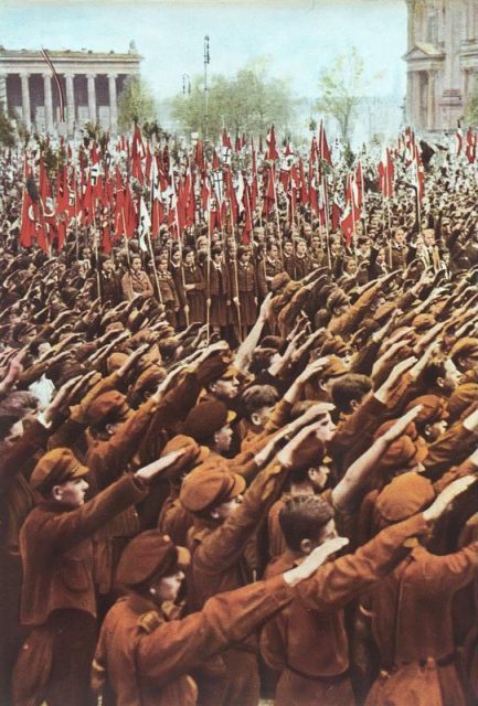 Hitler Youth members performing the Nazi salute at a rally at the Lustgarten in Berlin, 1933. Photo by Bundesarchiv, Bild CC BY-SA 3.0 de