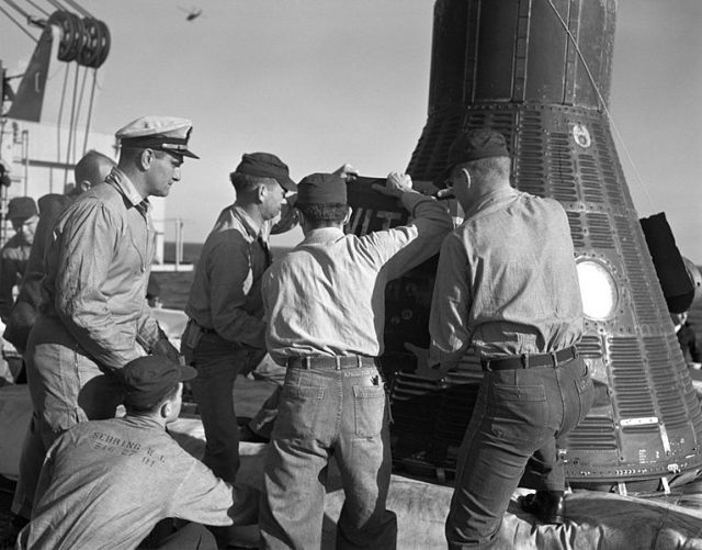 Recovery personnel aboard the USS Donner remove Ham, a 37-pound chimpanzee, from a Mercury-Redstone spacecraft